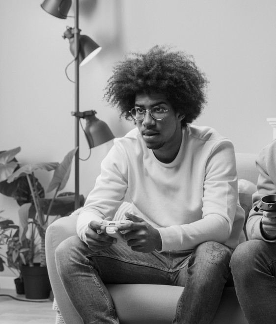 Man with a games controller on a couch