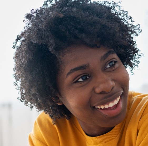 Woman in a yellow sweater laughing